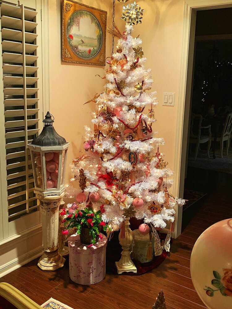 vintage and antique white Christmas tree and red and pink ornaments and decorations