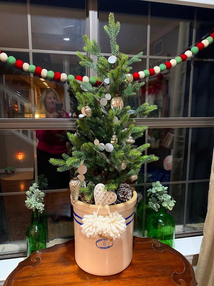 vintage small Christmas tree in farmhouse crock on tabletop